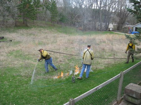 little drips of fire from a canister and the hose used to wet down the perimeter